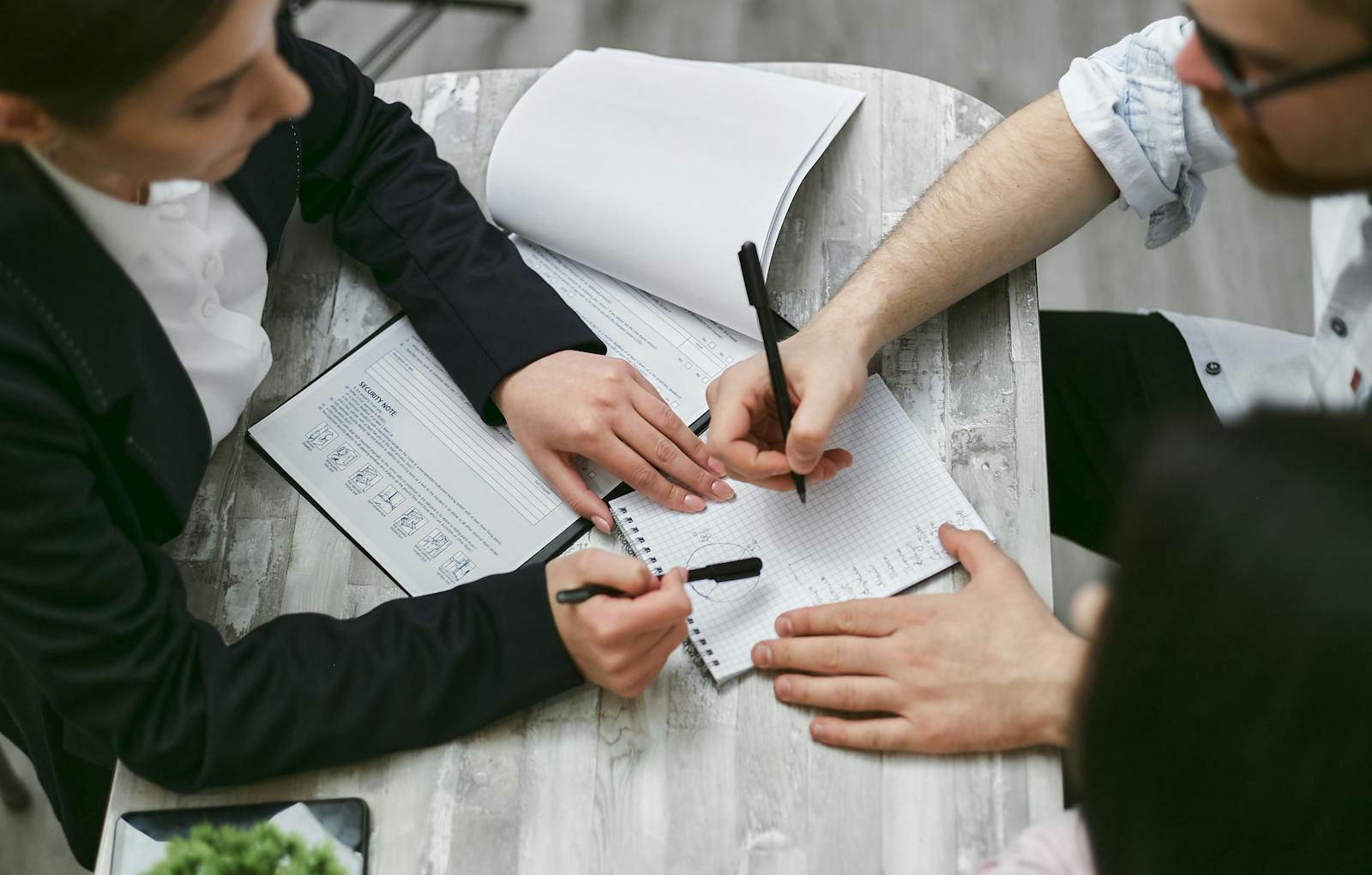 Person Writing on White Paper