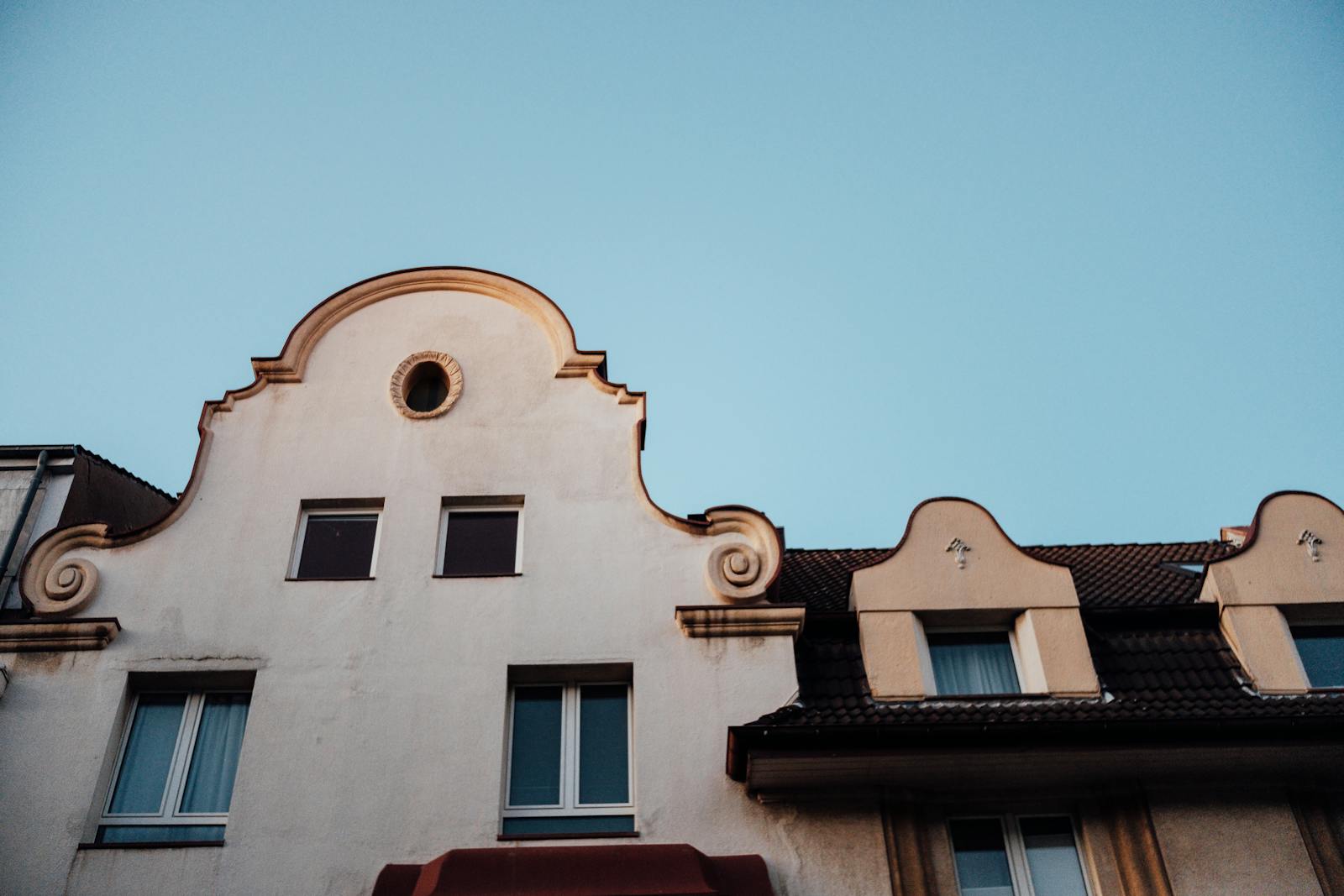 Architectural detail of a multi-story building. The image shows the ornate facade of a building, featuring arched window openings and decorative elements, likely part of a historic or wel...