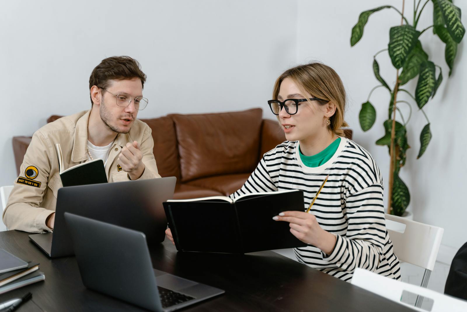 Two colleagues engaged in a brainstorming session at a contemporary office workspace.