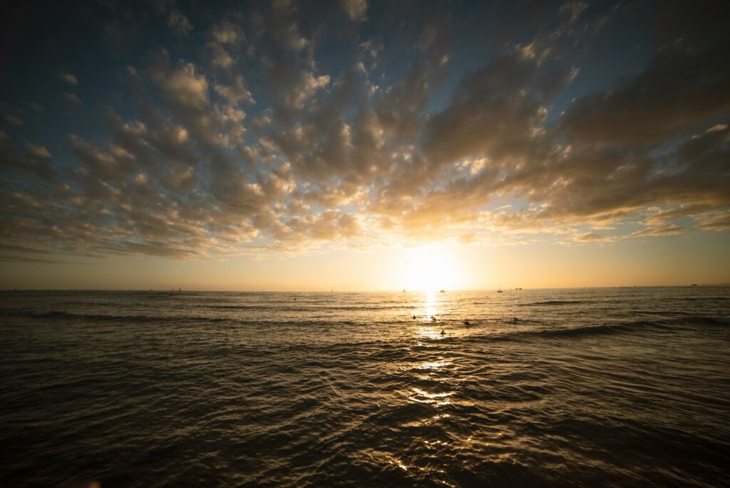 calm sea under white and blue sky