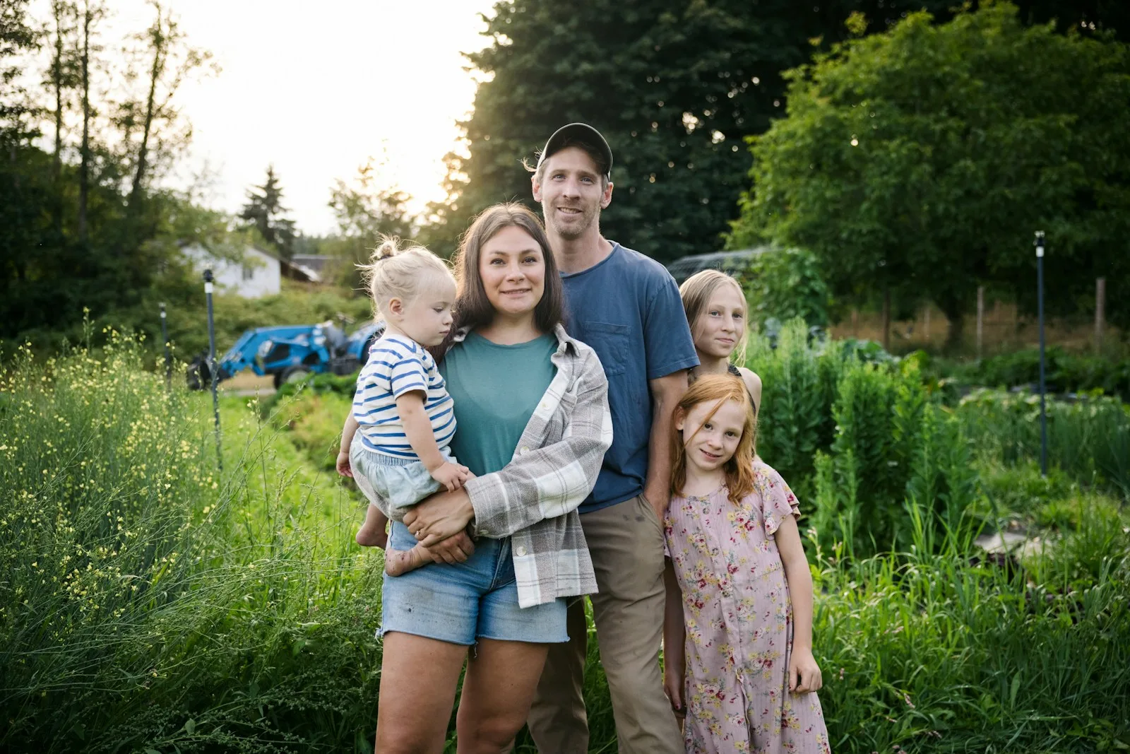 Family posing in a lush garden setting