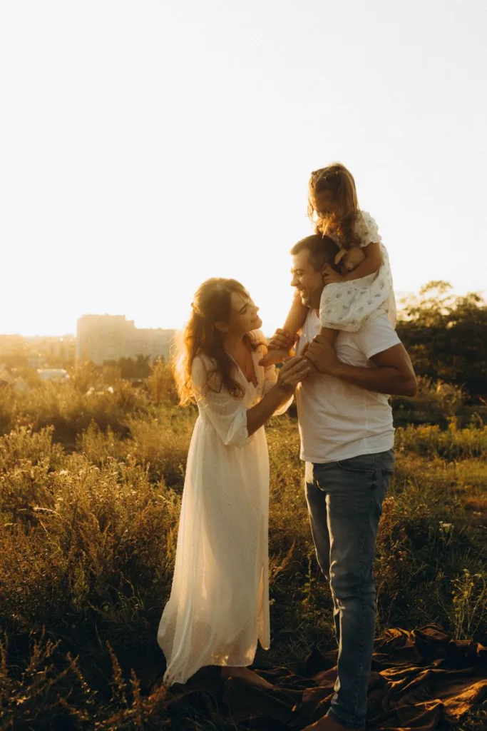 happy family in a sunny field at sunset